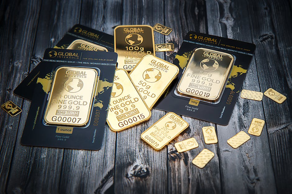 A collection of fine gold bars displayed on a textured wooden surface